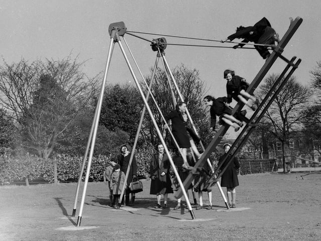 Children on swings in Beveridge Park, Kirkcaldy, Fife.