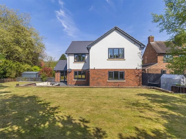 To the rear of the property, there is an enclosed, south facing, landscaped garden featuring a substantial L-shaped patio which extends across the full width of the property with a low retaining walled boundary. Beyond here, steps lead up to a raised lawn with low, vertical sleepers to the borders with established hedgerow and trees to the far boundaries.