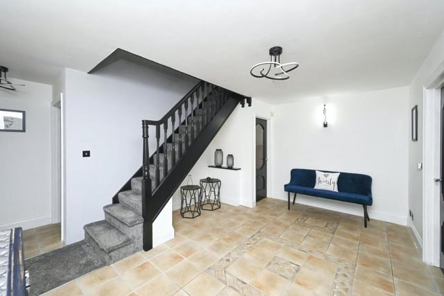 Even the ground-floor landing is attractive, with doors leading out on to a covered veranda, a storage cupboard and stairs to the first floor.