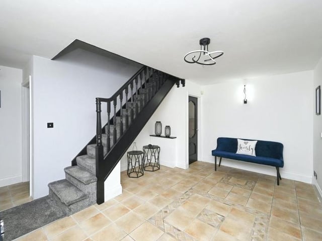 Even the ground-floor landing is attractive, with doors leading out on to a covered veranda, a storage cupboard and stairs to the first floor.