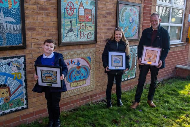 Freddie Walkington, eight, Ruby Allard, nine, with Coun Julian Siddle, who is holding Hunter Neal’s work who was unable to attend.