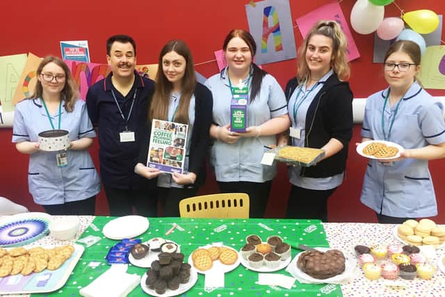 Martin Cook (second left) with health and social care students at their coffee morning for Macmillan Cancer Support