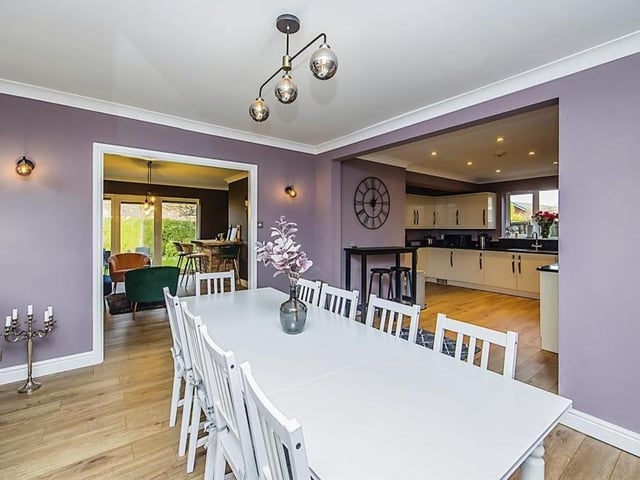 The spacious kitchen at the £525,000-plus house includes this smart dining area. In the background is the bar and to the right is the kitchen.