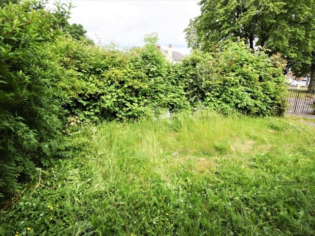 The garden at the front of the bungalow is mainly lawn. There is a second garden at the back, although it is swamped by shrubbery at present.