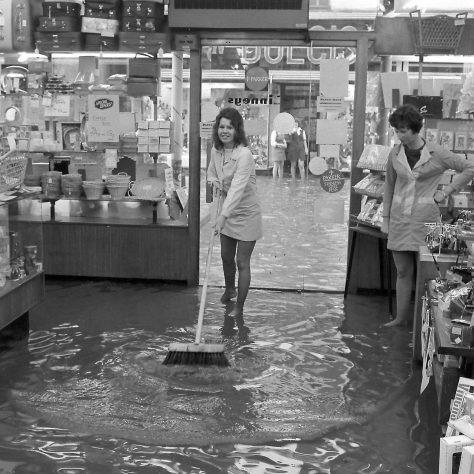 16-year-old Karen Ball swept the flood water at Linneys on Westgate.