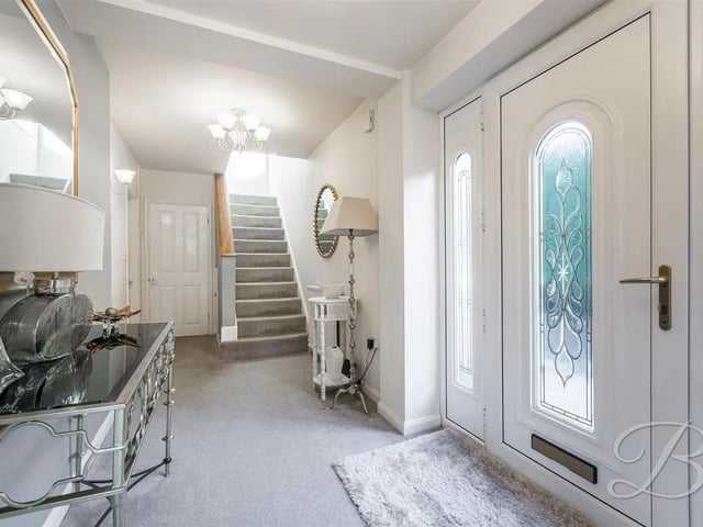The welcoming spacious entrance hall has built in storage under the stairs and two central heating radiators.