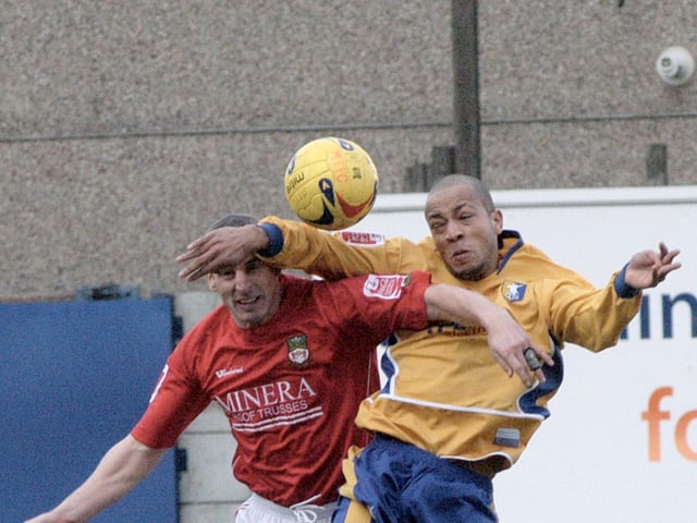 Alex Baptiste goes up for a header.