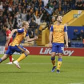 Mansfield Town forward Rhys Oates celebrates his goal against AFC Wimbledon before going off injured.