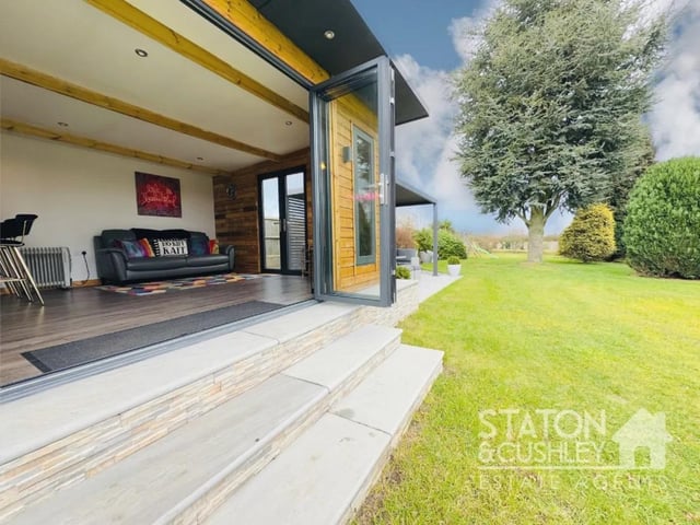 The property benefits from an outdoor summer house.