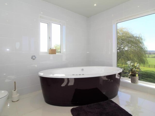 The first floor of the house also contains this distinctive family bathroom, dominated by a modern, free-standing bath.