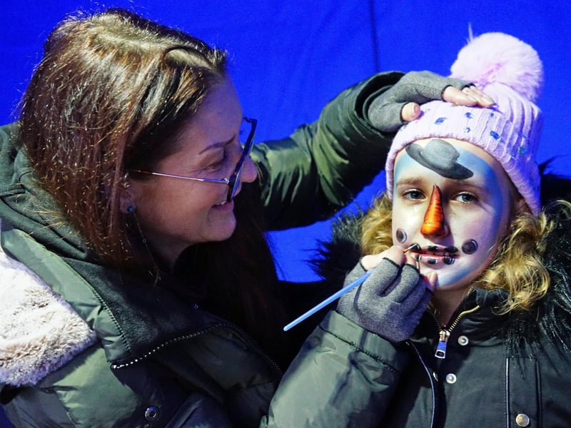Ellie Boden having her face painted by Lorraine at Mansfield's Cosy Christmas Market