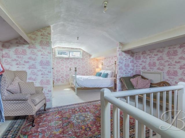 Just when you think you've seen everything the property has to offer, you can pop up to the roof space on the second floor and find this sixth bedroom, with fitted carpets, a fitted wardrobe and dual-aspect windows.