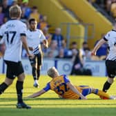 Mansfield Town midfielder George Lapslie gets the tackle in during the Carabao Cup first round match against Derby County FC at the One Call Stadium
Photo Credit Chris HOLLOWAY / The Bigger Picture.media