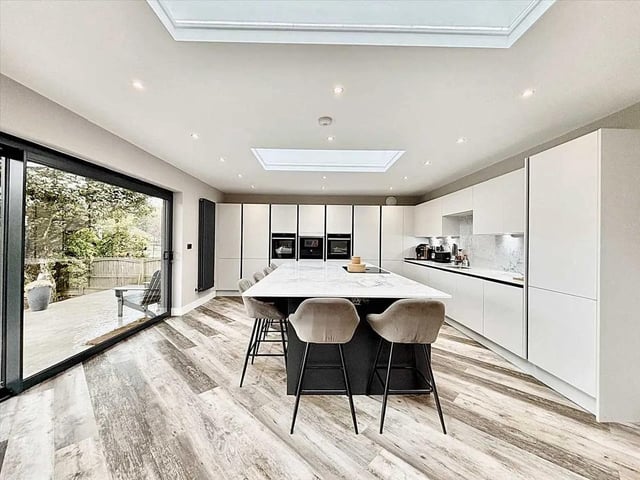A truly spectacular residence, this home has been transformed by a breathtaking extension to create a show piece of modern living. At the heart of the property lies a magnificent open-plan lounge and kitchen area, flooded with natural light thanks to expansive sliding glass doors that seamlessly blend indoor elegance with the beauty of the garden. The kitchen is a statement of sophistication and practicality, boasting an induction hob with inbuilt extractor fan, fitted into the island which also creates a breakfast area, integrated fridge/freezer, Neff dishwasher, twin ovens, microwave, warming drawer and wine cooler, the perfect blend of cutting-edge technology and sleek design. Perfect for hosting a dinner party or enjoying family evenings.