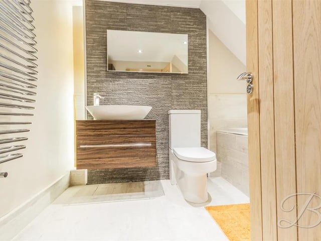 The stylish family bathroom is the perfect place to unwind after a busy day with an impressive three-piece suite comprising a bath, a low-flush WC, and a hand wash basin, all set against stylish tiled surroundings.