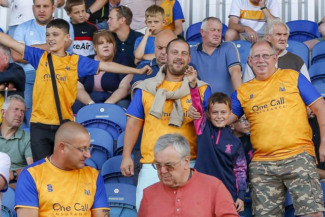 Mansfield Town fans watch the Carabao Cup first round match against Derby County.