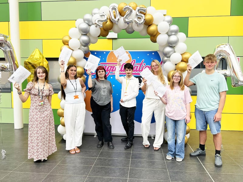Students from the college celebrate their results.