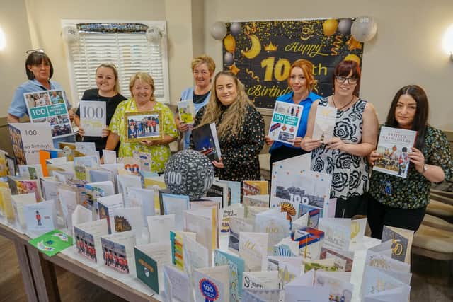 Staff at the home with the hundreds of cards sent to Jim for his 100th birthday. (Photo: Brian Eyre/NationalWorld)