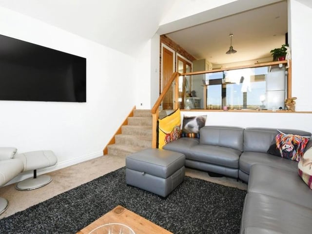 Down a short fight of stairs from the kitchen, you will find this second living room. An ideal place to relax in front of the TV.