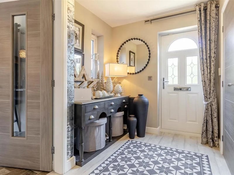 The luxury entrance hall has lvt flooring, built-in storage cupboard, stairs to the first floor landing and double doors opening through to the lounge.
