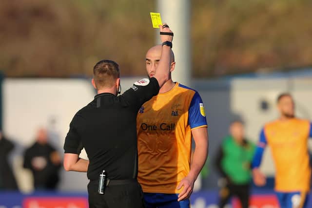 Mansfield Town defender Farrend Rawson receives a yellow card on Saturday - worse was to come. Photo by Chris Holloway/The Bigger Picture.media