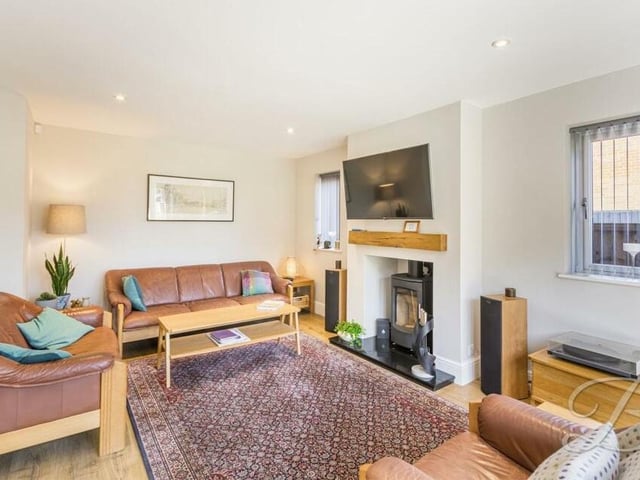 The ground floor of the £535,000 property is graced by two fine reception rooms, including this one, which is distinguished by a characterful log-burner that creates a warm and cosy atmosphere.
