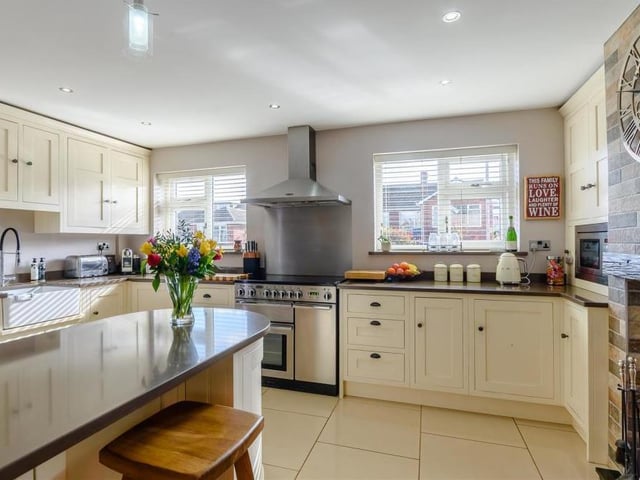 The modern kitchen oozes style, with its shaker cabinets, wall cupboards, base units and drawers with quartz worktops above. An island breakfast bar also boasts matching shaker base units and quartz worktops, while an inset Belfast sink has a built-in drainer and mixer tap.