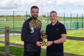 Stephen McLaughlin receives his trophy last year from Chad sports editor John Lomas.