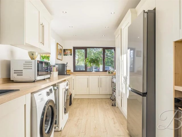 Complete with a range of matching wall and base cabinets, inset sink and drainer and ample worktop space along with further space and plumbing for a washing machine, tumble dryer and a fridge freezer.