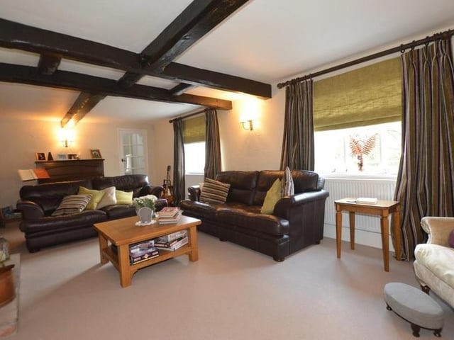 The large living room exemplifies the character of the Southwell property. It features a beamed ceiling and two Gothic arched Yorkshire casement windows to the front of the house.
