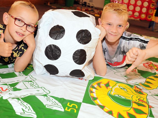 Mansfield Museum Toys, Games and Puzzles day 2019. Jack Dunne 6, gets on the right side of a snakes and ladders game, whilst brother, Harvey, 12, rues a bad throw of the dice.