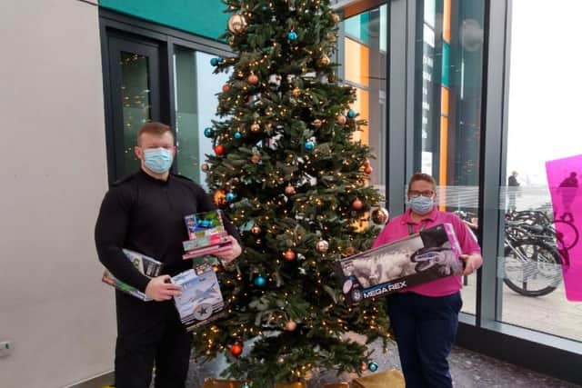 Nottinghamshire police officer Spencer Pugh hands over the collected toys at King's Mill Hospital
