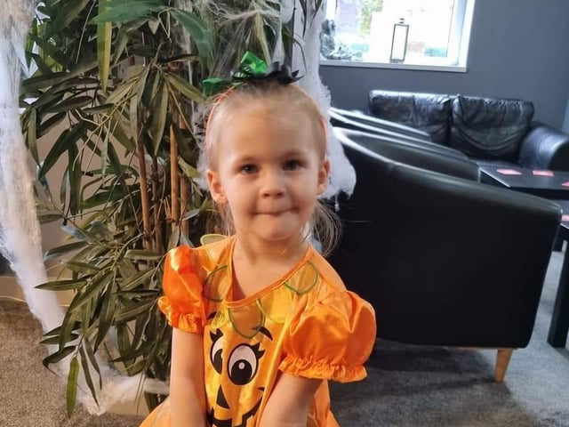 Isabella dressed as a pumpkin.