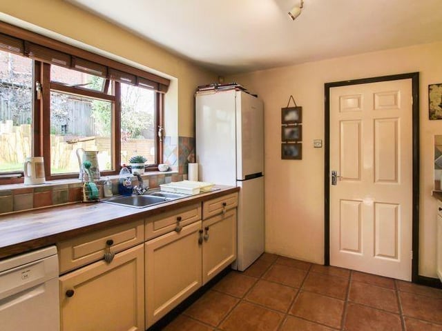A third shot of the kitchen. As you can see, there is room for appliances, including a fridge freezer. The floor is tiled, and there is a soft wood double-glazed window to the back of the £320,000 house.