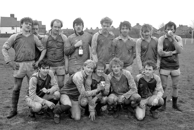 The Huthwaite FC side from 1986 gather after a game. Perhaps a big game won judging by what the goalkeeper is holding.