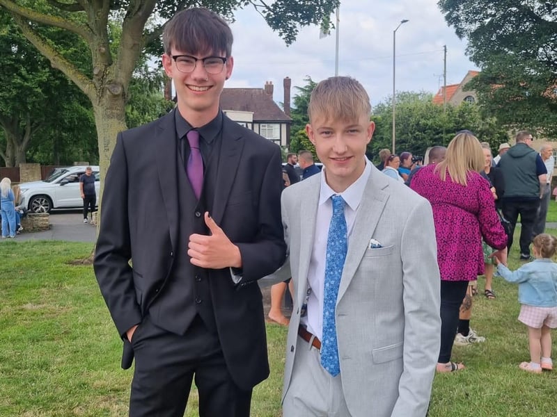 Young men looking dapper in their prom suits.