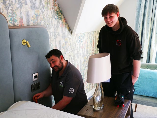 Maintenance operative Jordan (left) working on electrical products in the bedrooms with Michael Ward