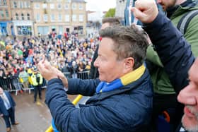 John Radford salutes fans on the promotion open top bus parade. Photo by Chris & Jeanette Holloway/The Bigger Picture.media