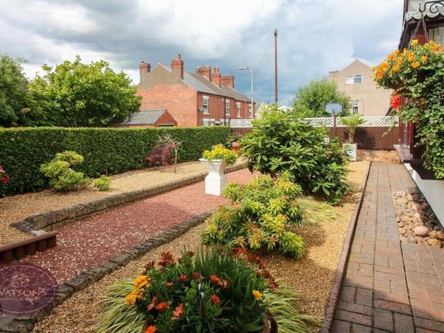 The front garden, shared by both the bungalow and the annexe, is beautiful. Well tended but low maintenance, it includes flowerbed borders, a range of mature plants and shrubs, and decorative gravel beds, all enclosed by wall and hedge borders.