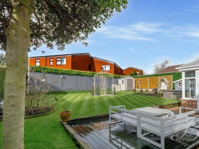 Another view of the landscaped rear garden, which is private and enclosed thanks to a fence and hedge surround.