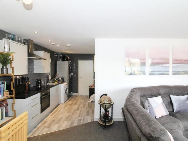 After its recent renovation, the open-plan living area, with lounge and kitchen, at the Stockwell Gate apartment is looking smart and stylish.