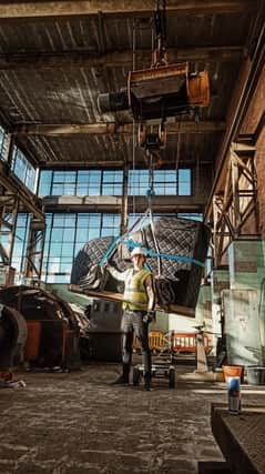 Chris Miggells with a grand piano being lifted into place at the former Clipstone Colliery buildings.