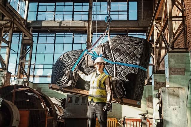 Chris Miggells with a grand piano being lifted into place at the former Clipstone Colliery buildings.