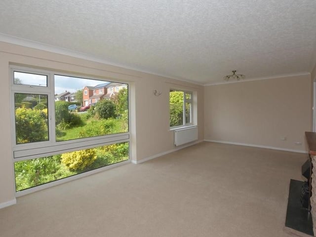 First stop on our tour of the Southwell bungalow is the bright living room or dining room, which faces the front of the property. There are two radiators and a coved ceiling.