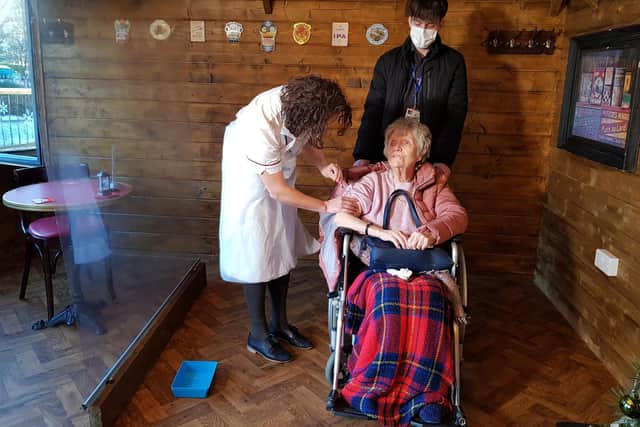 June Phelps being vaccinated by Olivia Swift at Ashmere Care Ltd