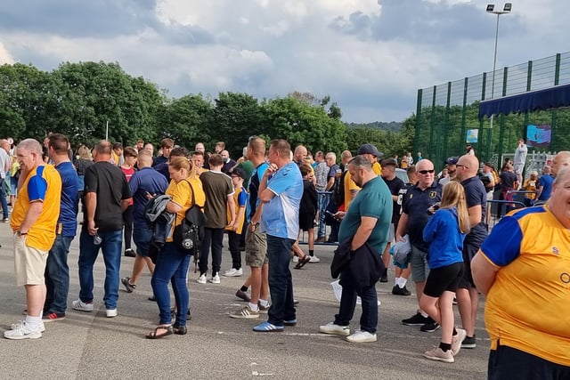 Fans gather outside the One Call Stadium