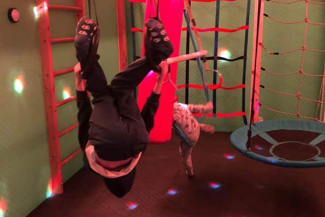 Children climbing and swinging on special play equipment in the Integration Room.