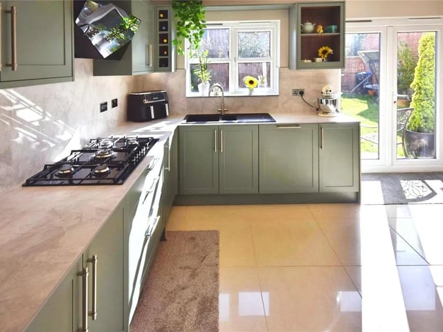 A simply Stunning room with a modern range of wall & base units with integrated appliances comprising of a fridge freezer, high level electric oven & microwave, 5 ring gas hob, plenty of storage & tiled flooring, a upvc double glazed window to the rear & side & French doors leading tot he rear garden.