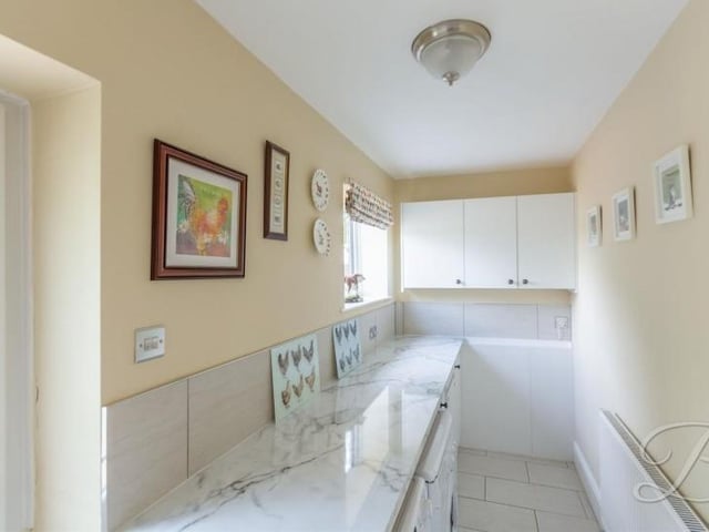 A handy utility room has space for appliances such as a washing machine.There is access to the downstairs toilet, and a door leading outside.