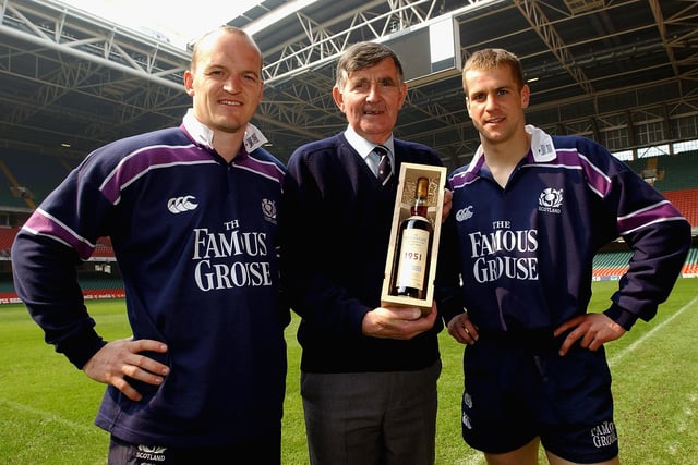 Bill McLaren is presented with a 50-year-old bottle of The Macallan whisky by Gregor Townsend and Chris Paterson in Cardiff ahead of his last Scotland commentary. McLaren began on BBC radio in 1953 and made the switch to television six years later.
